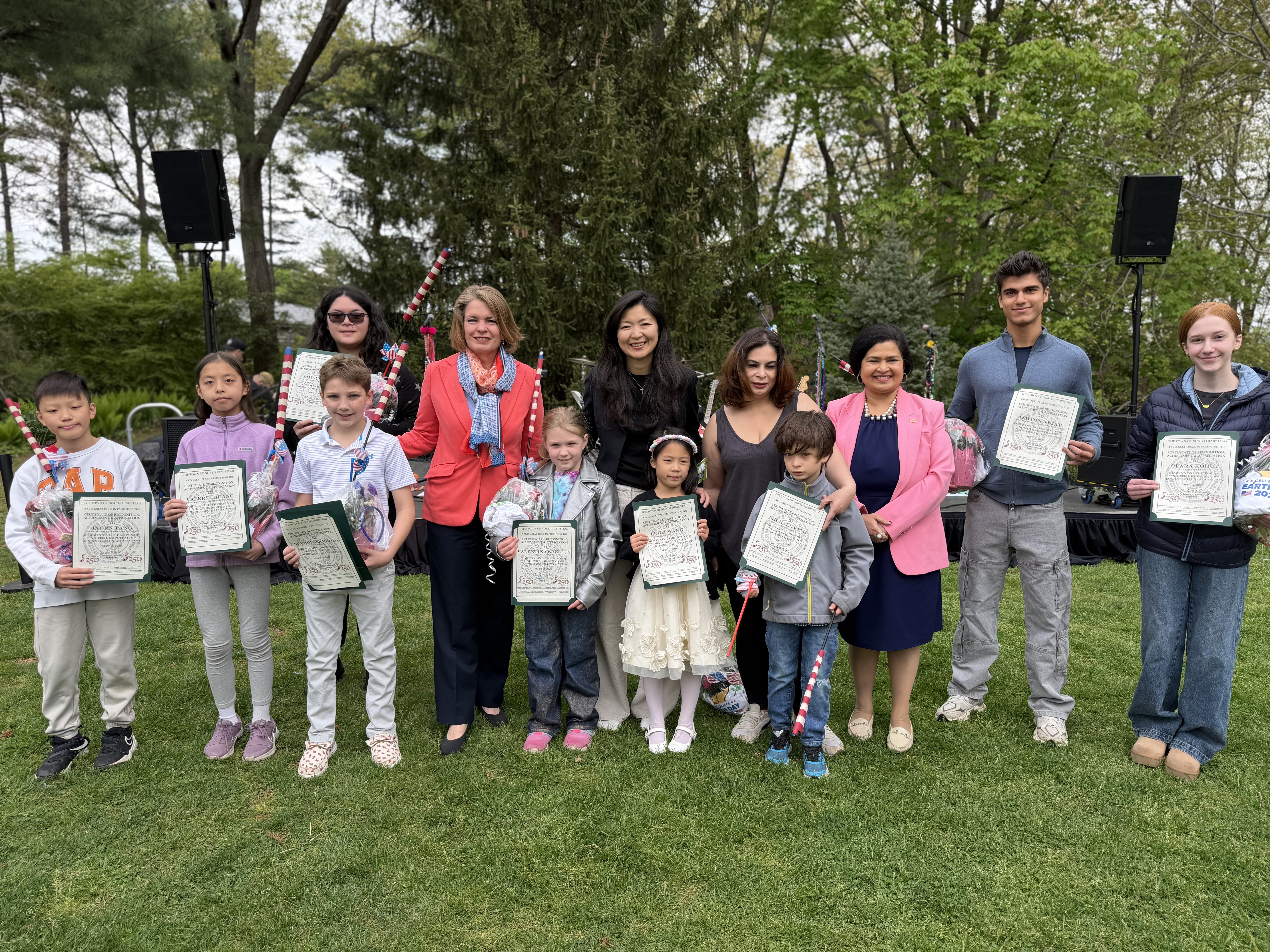 Supervisor Jennifer S. DeSena and Town Board members gather outdoors with the recognized student artists, each holding their America 250 certificate of achievement.