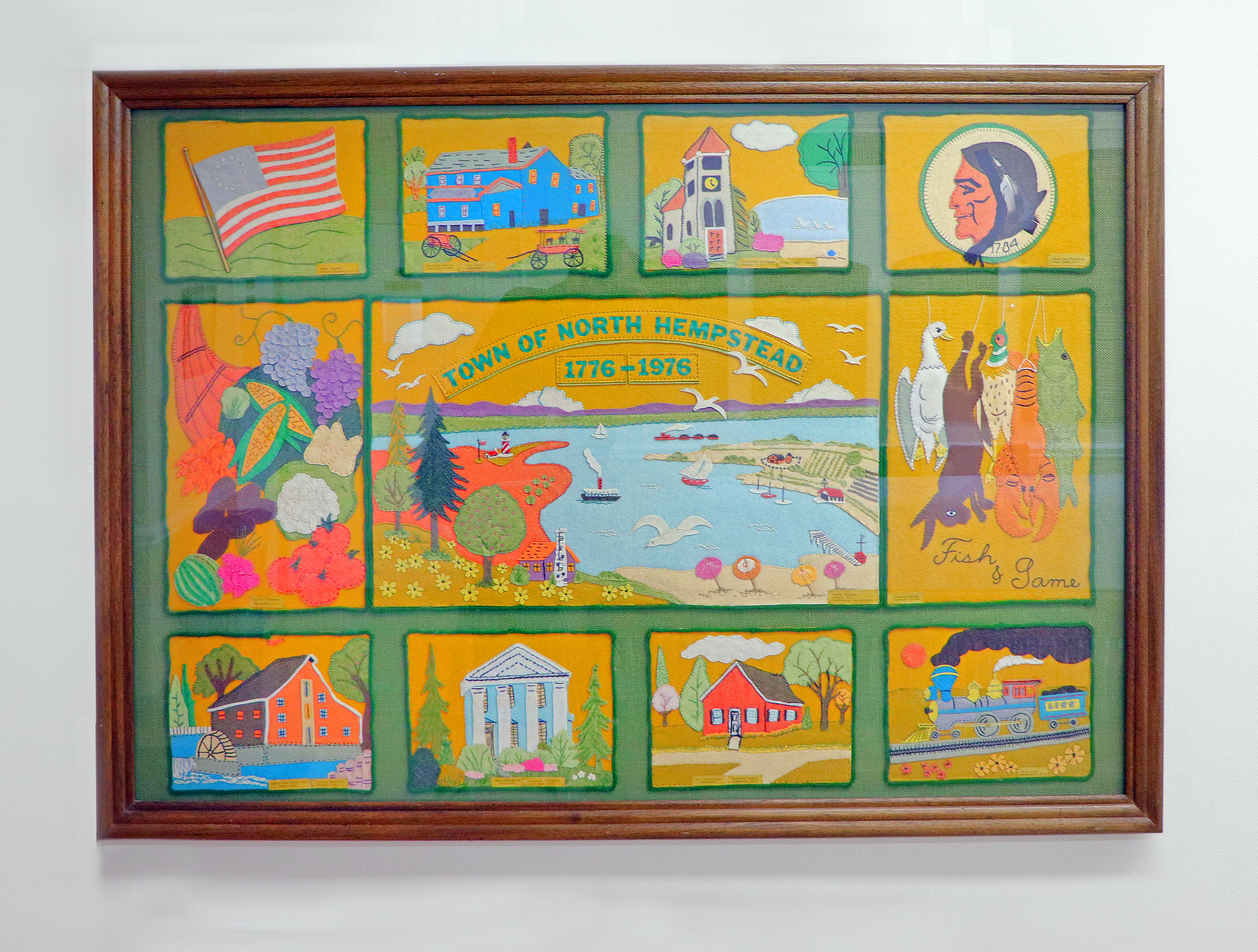 The Town of North Hempstead 1776–1976 Bicentennial tapestry, depicting local landmarks, wildlife, and community scenes in colorful needlework.